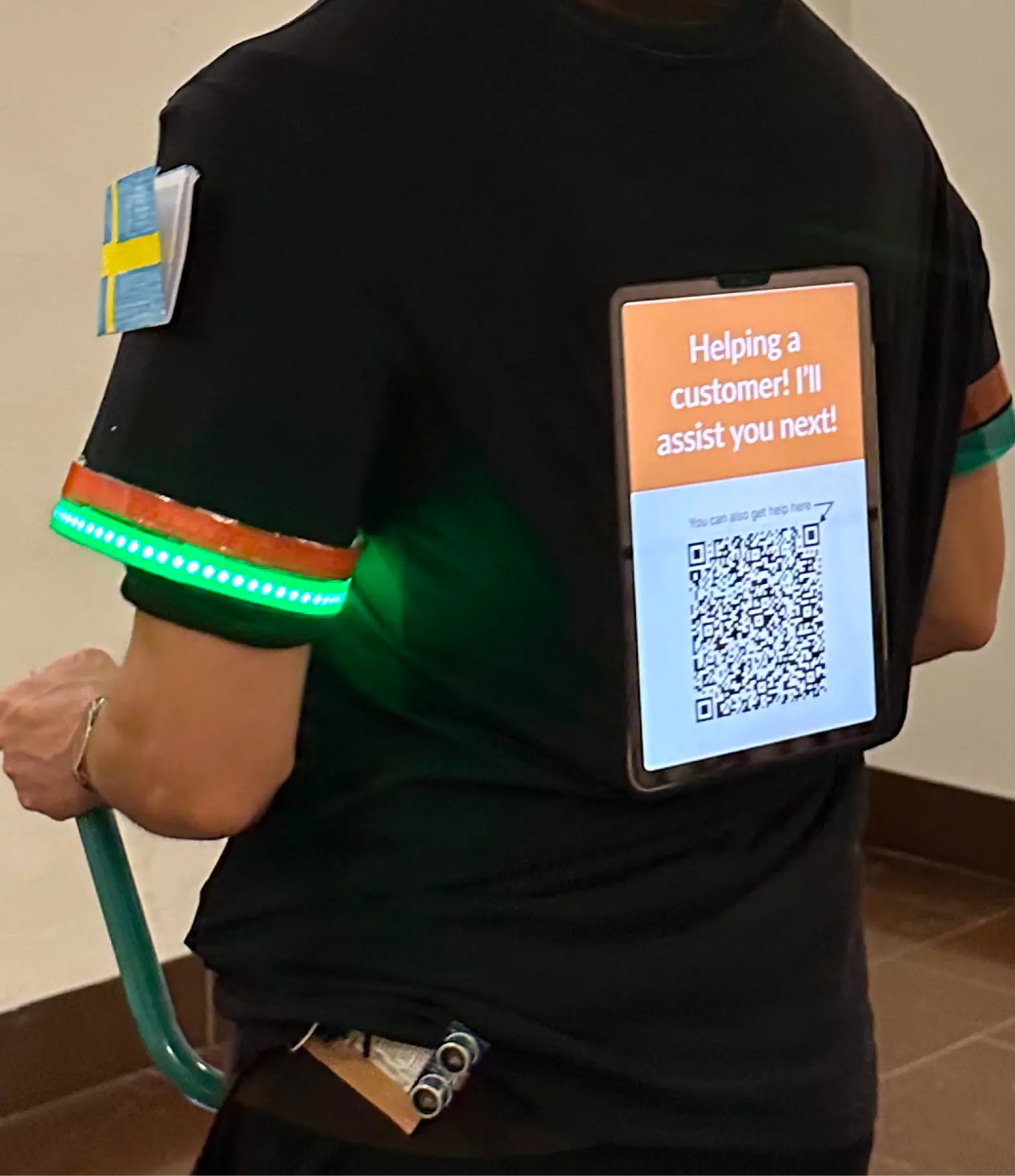 E-Textile shirt Prototype with LED cuffs and Screen with QR Code on the back.